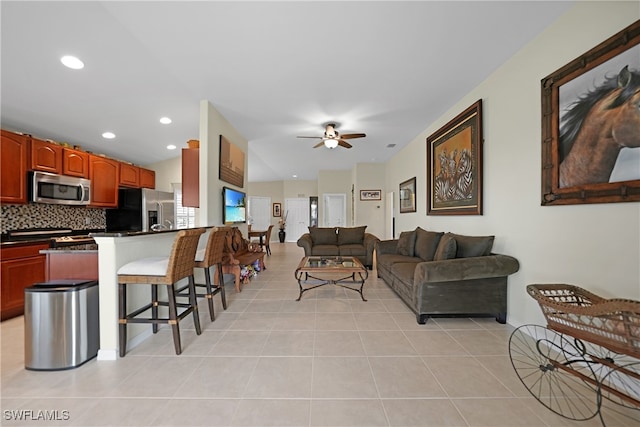 tiled living room with ceiling fan