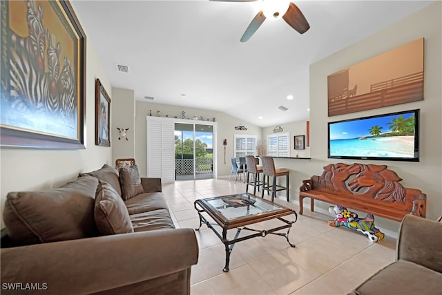 tiled living room with ceiling fan and vaulted ceiling