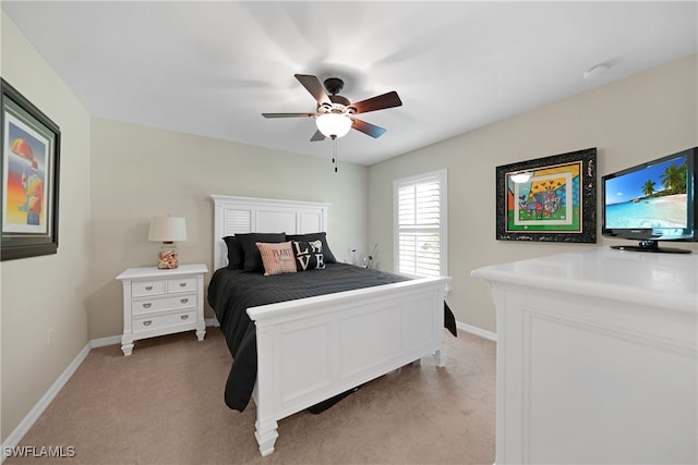 bedroom featuring light carpet and ceiling fan