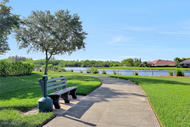 view of community with a water view and a lawn