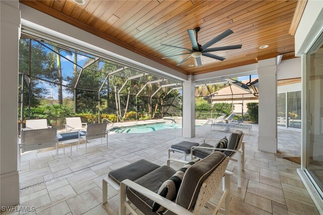 view of patio / terrace featuring glass enclosure and ceiling fan