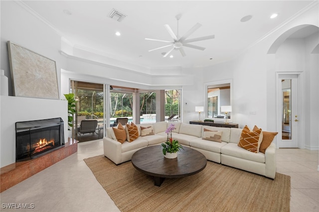 living room featuring light tile patterned floors, ceiling fan, and ornamental molding