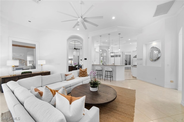 tiled living room featuring ceiling fan and crown molding