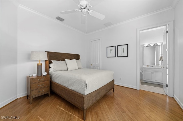 bedroom featuring light hardwood / wood-style floors, ensuite bath, ceiling fan, and crown molding