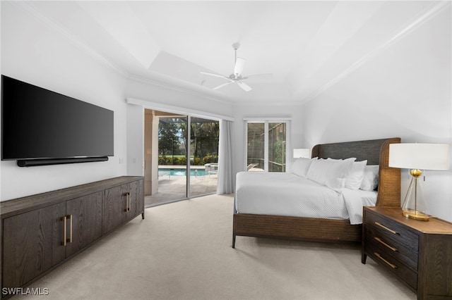 carpeted bedroom featuring ceiling fan, access to exterior, ornamental molding, and a tray ceiling