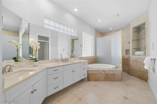 bathroom with tile patterned flooring, vanity, and separate shower and tub