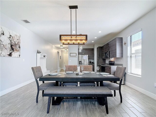 dining room with a healthy amount of sunlight and light wood-type flooring