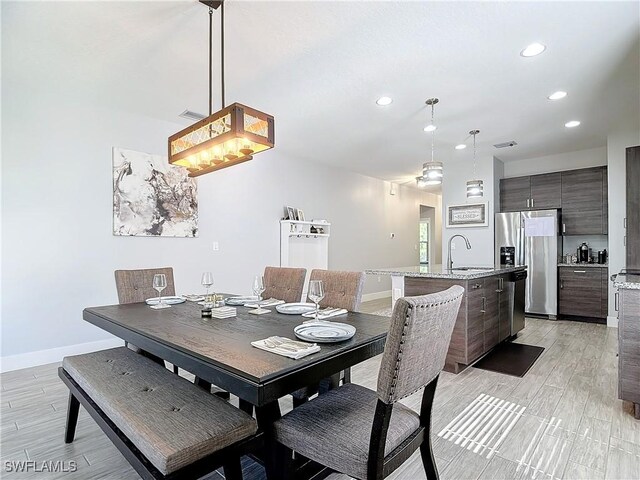 dining area featuring light hardwood / wood-style floors and sink