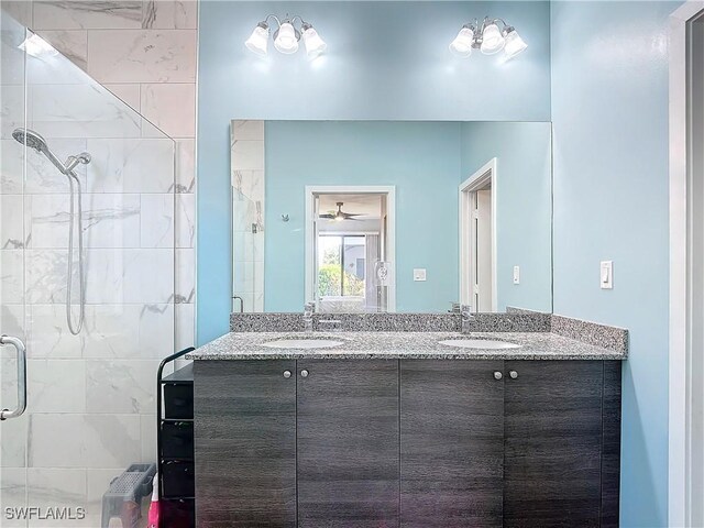 bathroom featuring a shower with door, vanity, and ceiling fan