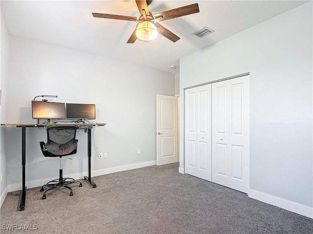 carpeted office featuring ceiling fan