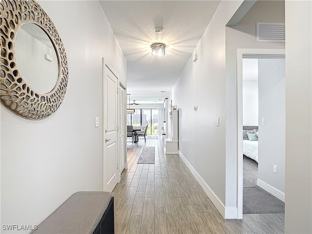 hallway with light hardwood / wood-style flooring