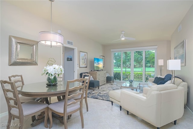 living area with a ceiling fan, visible vents, and light tile patterned floors