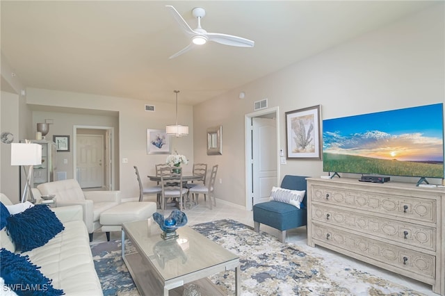 living area with ceiling fan, visible vents, baseboards, and light tile patterned flooring