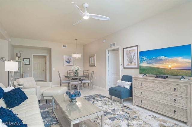 living room featuring light tile patterned floors, baseboards, a ceiling fan, and visible vents