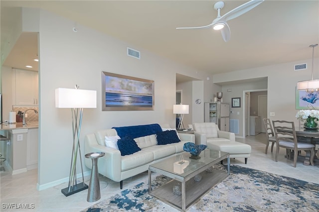 living room featuring a ceiling fan, light tile patterned flooring, and visible vents
