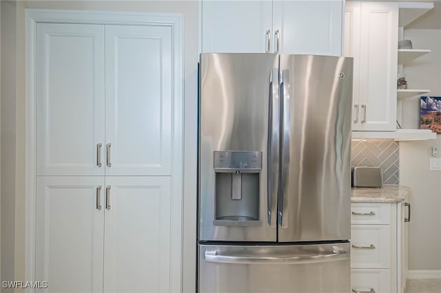 kitchen with white cabinets, open shelves, decorative backsplash, and stainless steel fridge with ice dispenser