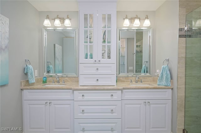 bathroom with a shower with door and vanity