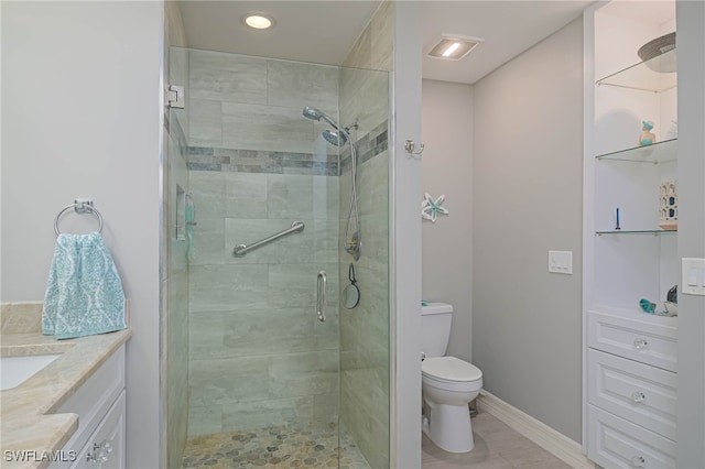 bathroom with tile patterned floors, a shower with shower door, toilet, and vanity