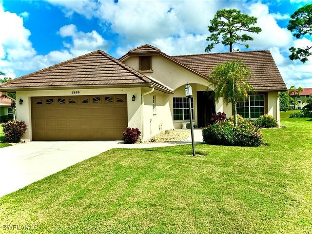 view of front of house with a garage and a front yard