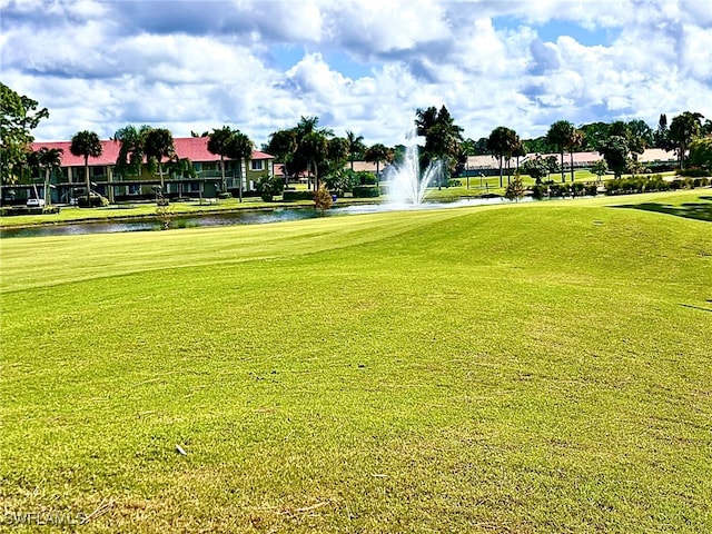 surrounding community featuring a water view and a yard