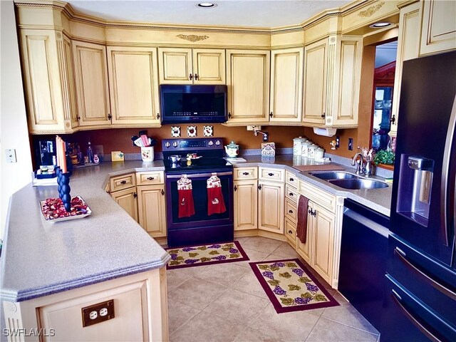 kitchen featuring black appliances, light brown cabinetry, sink, and light tile patterned floors