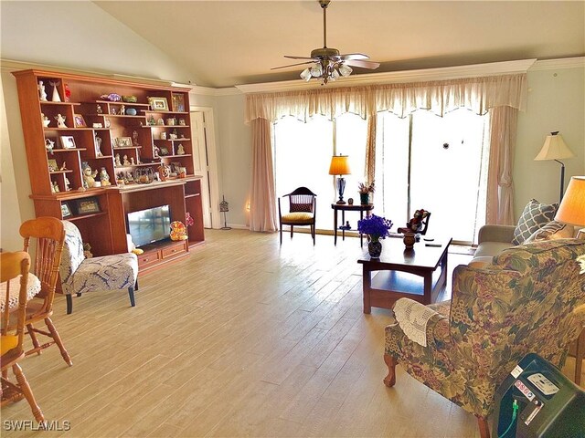 living room featuring ornamental molding, lofted ceiling, hardwood / wood-style floors, and ceiling fan