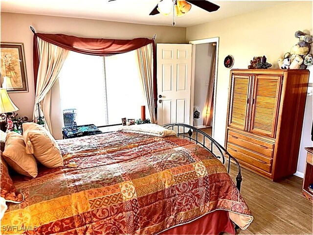 bedroom with ceiling fan and hardwood / wood-style flooring