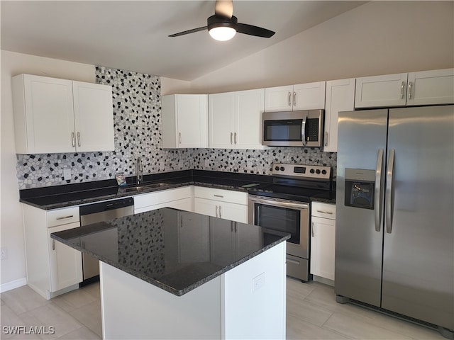 kitchen with vaulted ceiling, ceiling fan, decorative backsplash, appliances with stainless steel finishes, and white cabinets