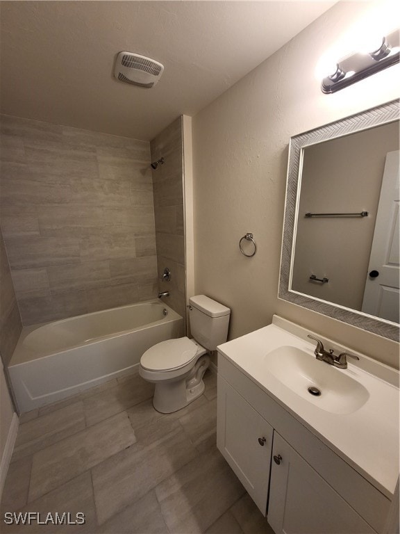 full bathroom with tiled shower / bath combo, vanity, and toilet