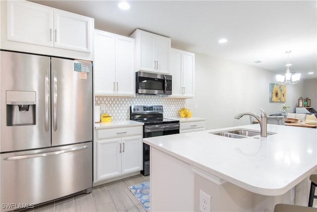 kitchen with tasteful backsplash, stainless steel appliances, light countertops, white cabinetry, and a sink