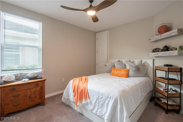 bedroom featuring baseboards, a ceiling fan, and light colored carpet