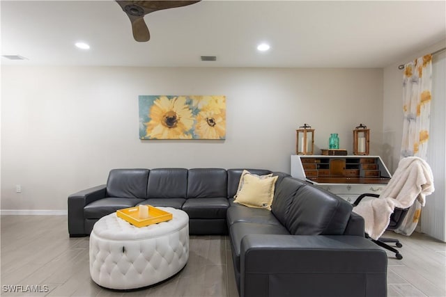 living room featuring light wood finished floors, baseboards, visible vents, and recessed lighting