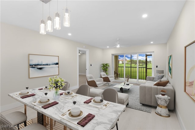 living room featuring ceiling fan and light hardwood / wood-style floors