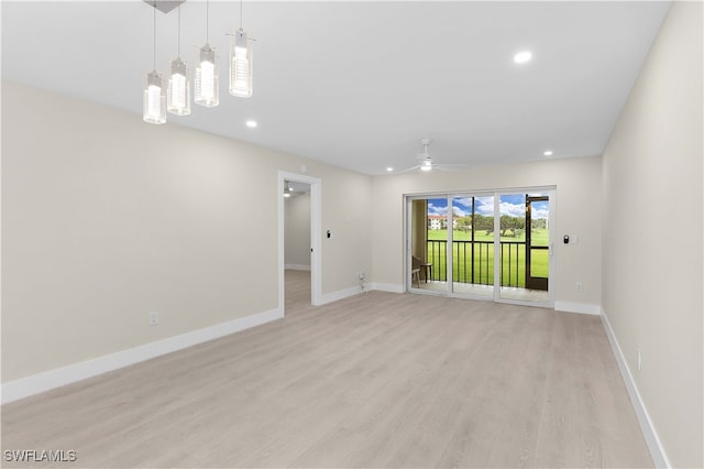 spare room with ceiling fan and light hardwood / wood-style floors