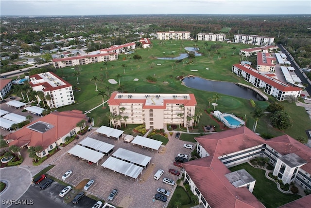 aerial view with a water view and view of golf course