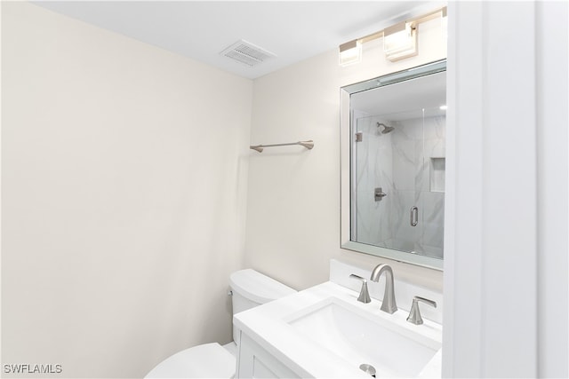 full bath with a marble finish shower, visible vents, vanity, and toilet