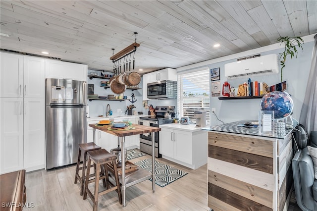 kitchen featuring white cabinets, appliances with stainless steel finishes, and wooden ceiling