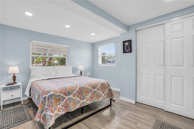 bedroom featuring a closet and light wood-type flooring