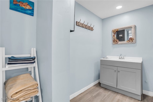 bathroom featuring wood-type flooring and vanity