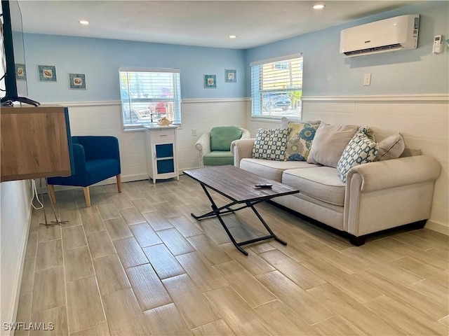 living room featuring a wall mounted air conditioner, wood finish floors, recessed lighting, and wainscoting