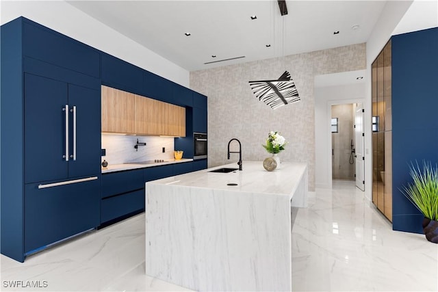 kitchen with modern cabinets, a peninsula, marble finish floor, black appliances, and a sink