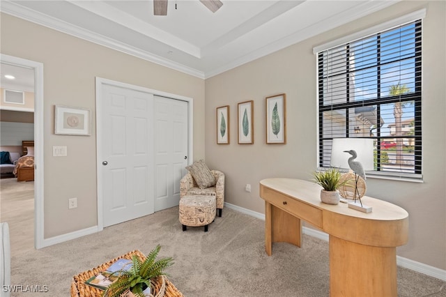 office featuring light colored carpet, ceiling fan, and ornamental molding