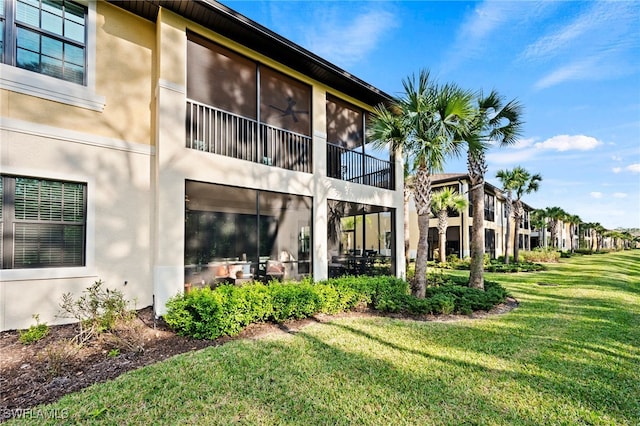 rear view of property featuring a lawn