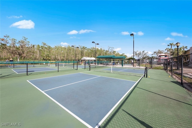 view of tennis court featuring basketball hoop