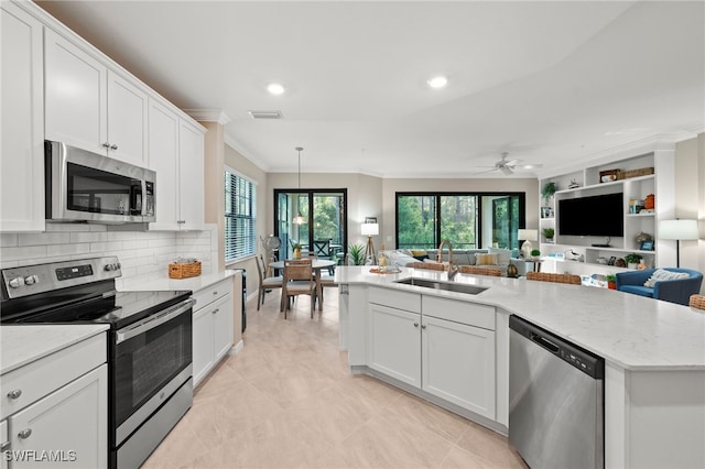 kitchen with white cabinetry, sink, ceiling fan, hanging light fixtures, and appliances with stainless steel finishes