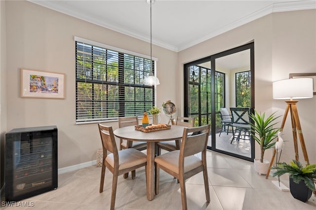 dining area with light tile patterned floors, baseboards, wine cooler, and ornamental molding