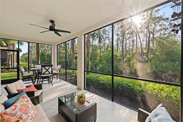 unfurnished sunroom featuring a ceiling fan