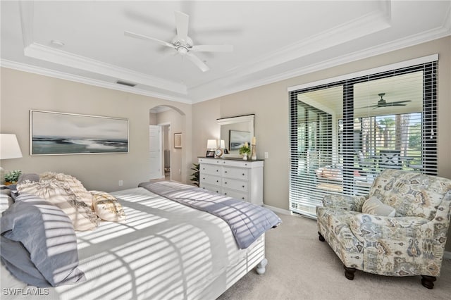 carpeted bedroom featuring a raised ceiling, ceiling fan, and ornamental molding