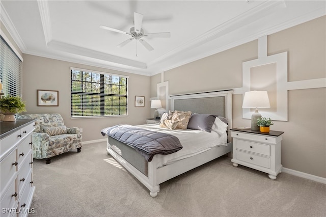 carpeted bedroom featuring a raised ceiling, ceiling fan, and crown molding