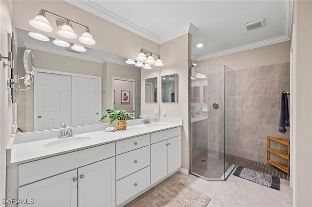 bathroom with tile patterned flooring, vanity, a tile shower, and crown molding